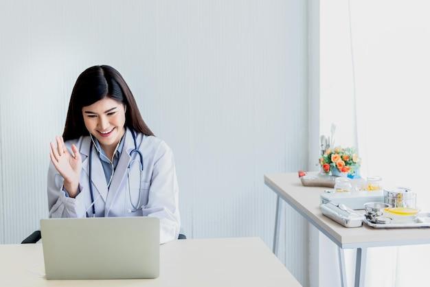 Woman doctor looking at and using a computer to provide advice to patients by communication online Premium Photo