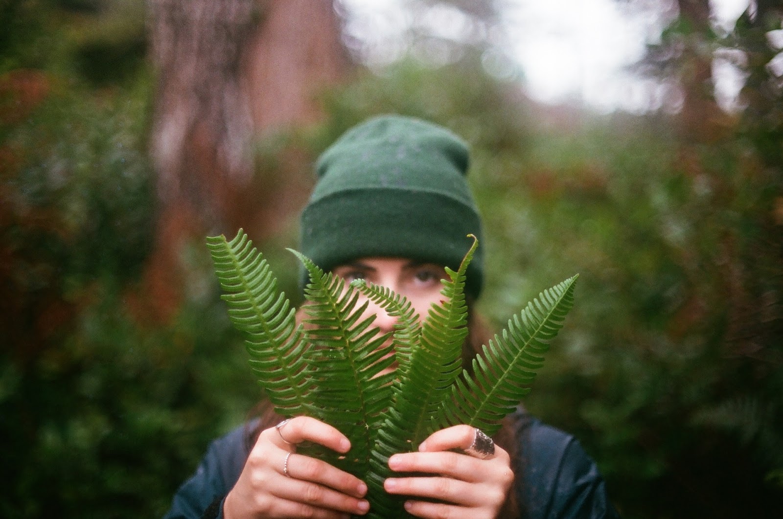 Woman holding green leaves