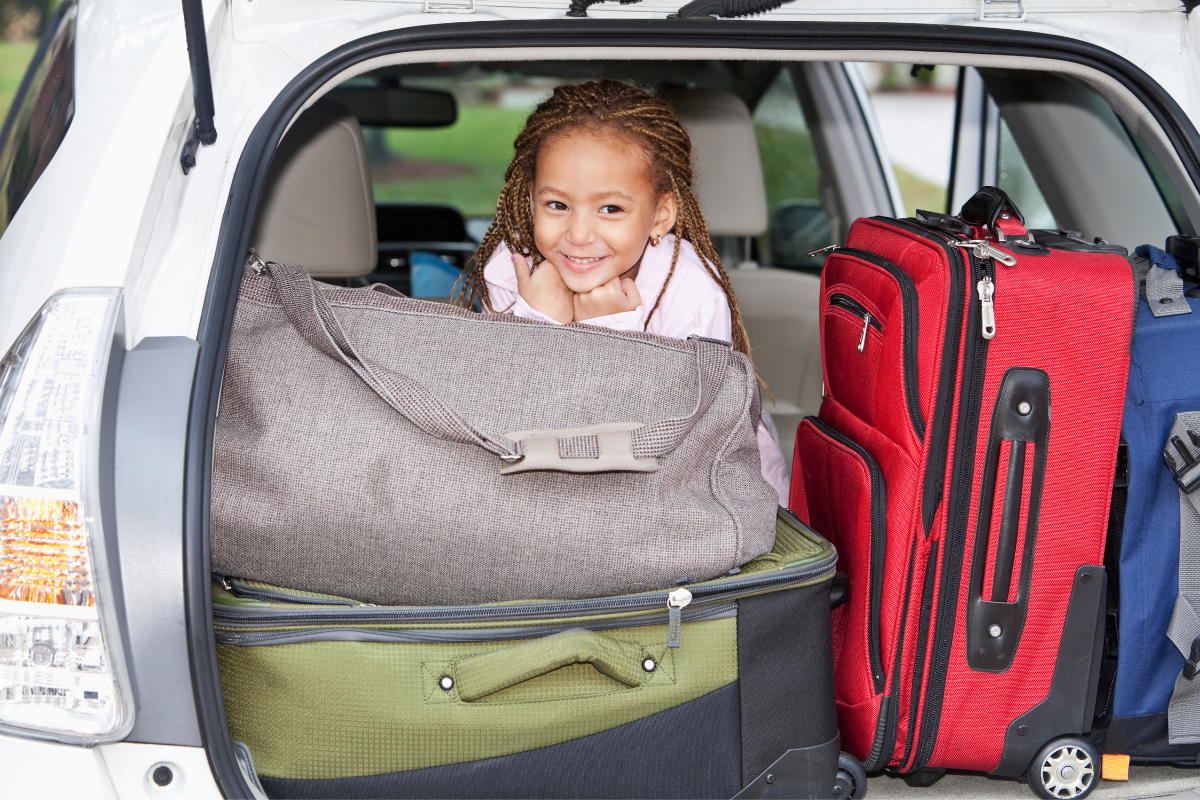 little girl in car parked for trip