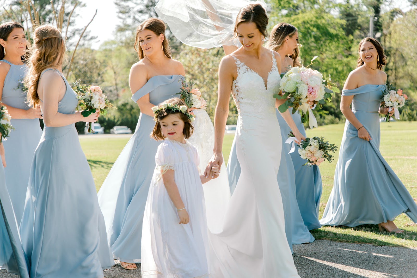 Bride walks holding hands with flower girl