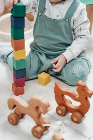 A child playing with blocks
Description automatically generated