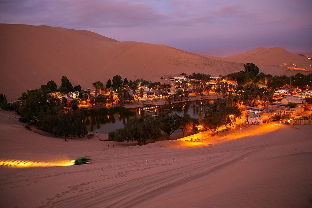 Oasis of Huacachina at night with dune buggy blurred motion, Ica region.Top Tourist Attractions in Peru