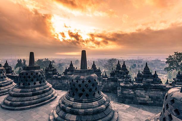 Buddist Temple of Borobudur at Sunrise in Java, Indonesia Sunrise on Borobudur temple the biggest buddhist monument of Asia Borobudur Temple stock pictures, royalty-free photos & images