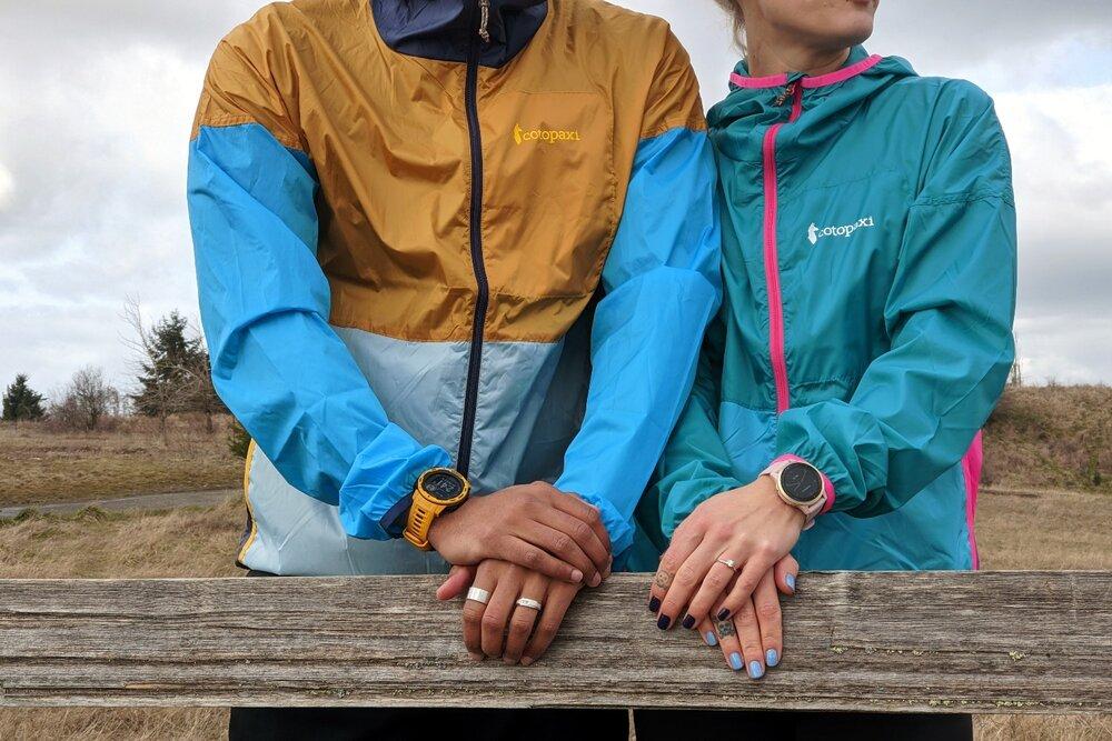 Two+people+standing+next+to+each+other+wearing+Cotopaxi+Teca+Windbreakers.jfif