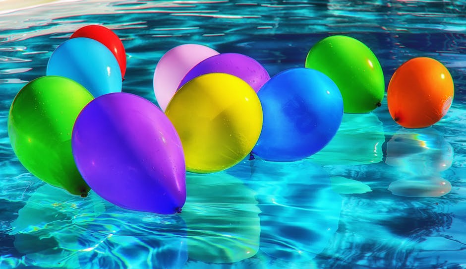 Purple Yellow and Blue Balloon on Swimming Pool