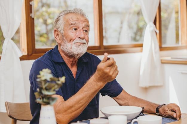 Elder loss of appetite boring food bad taste unhappy when eating meal during stay home Premium Photo