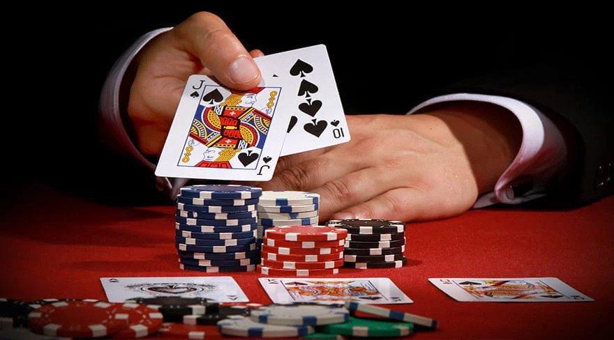 Blackjack table with poker chips and playing cards. 