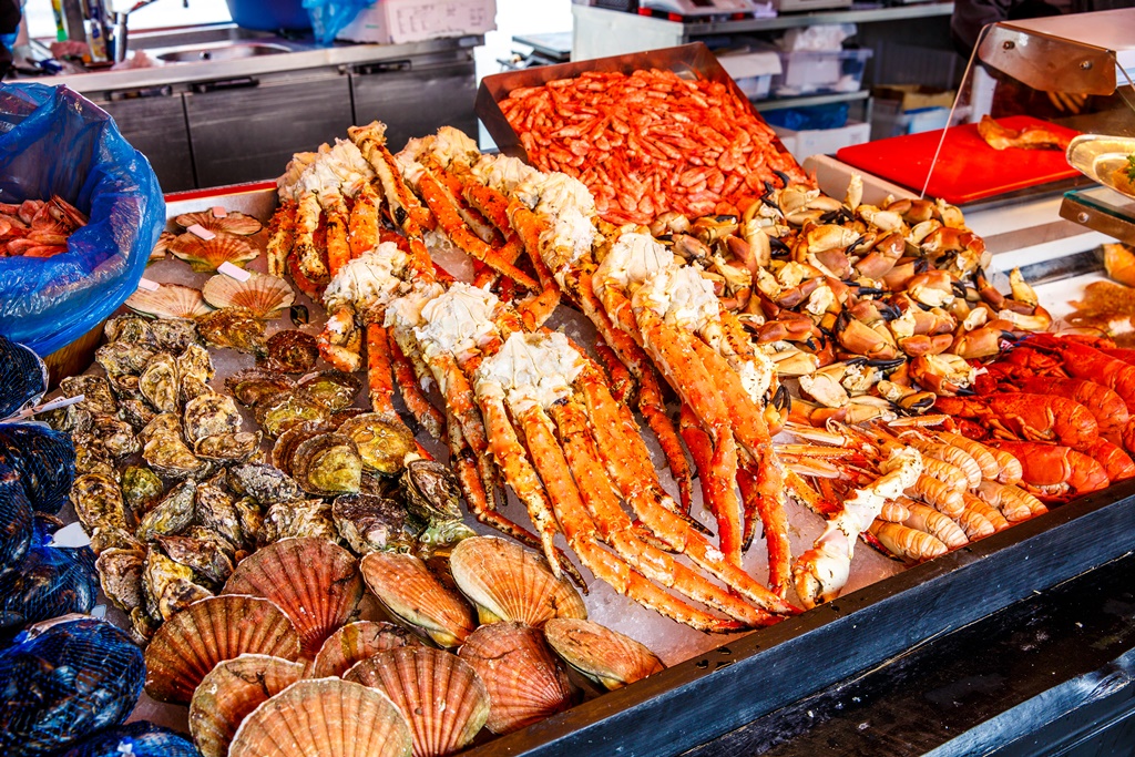 Various seafood on the shelves of the fish market in Norway