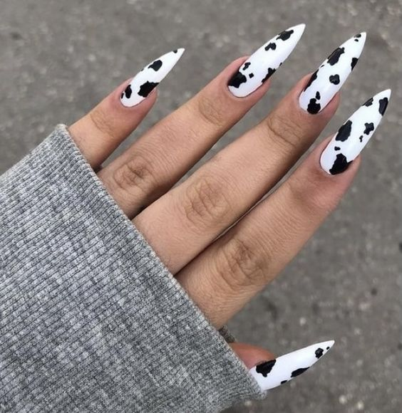 Full picture of lady rocking the cow print nails 