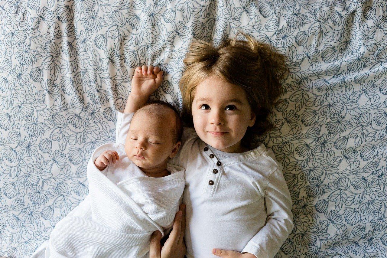 A newborn with a sibling