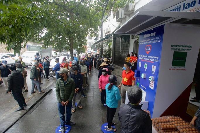 Rất đông người dân đến xếp hàng để nhận thực phẩm hỗ trợ của Báo Người Lao Động.