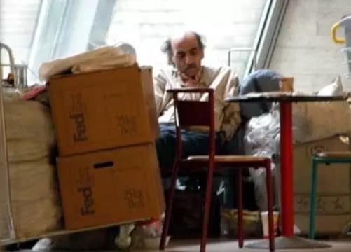 His name is Mehran Karimi Nasseri, and he is an Iranian refugee who lived in Terminal 1 at Charles de Gaulle Airport in Paris from Aug. 8, 1988, until July 2006. After fleeing Iran, he sought refuge in a number of different countries and lost his passport en route in England, stranding him in the French airport.