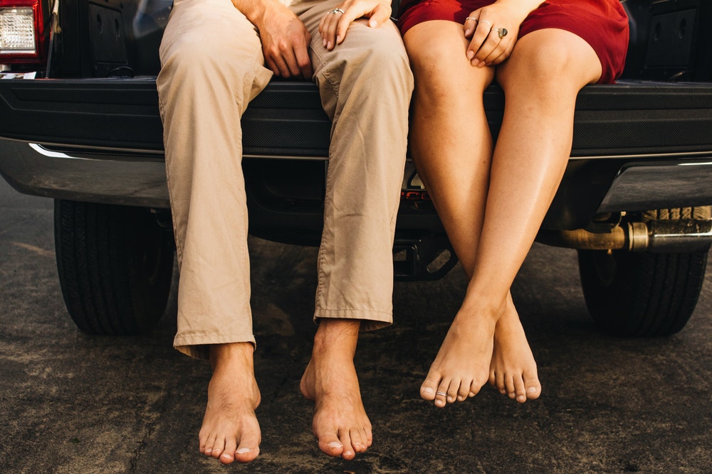 man and woman seating on truck bed