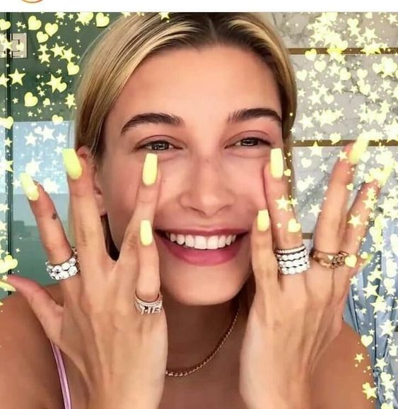 Hailey shows off her yellow butterfly nails for all to see
