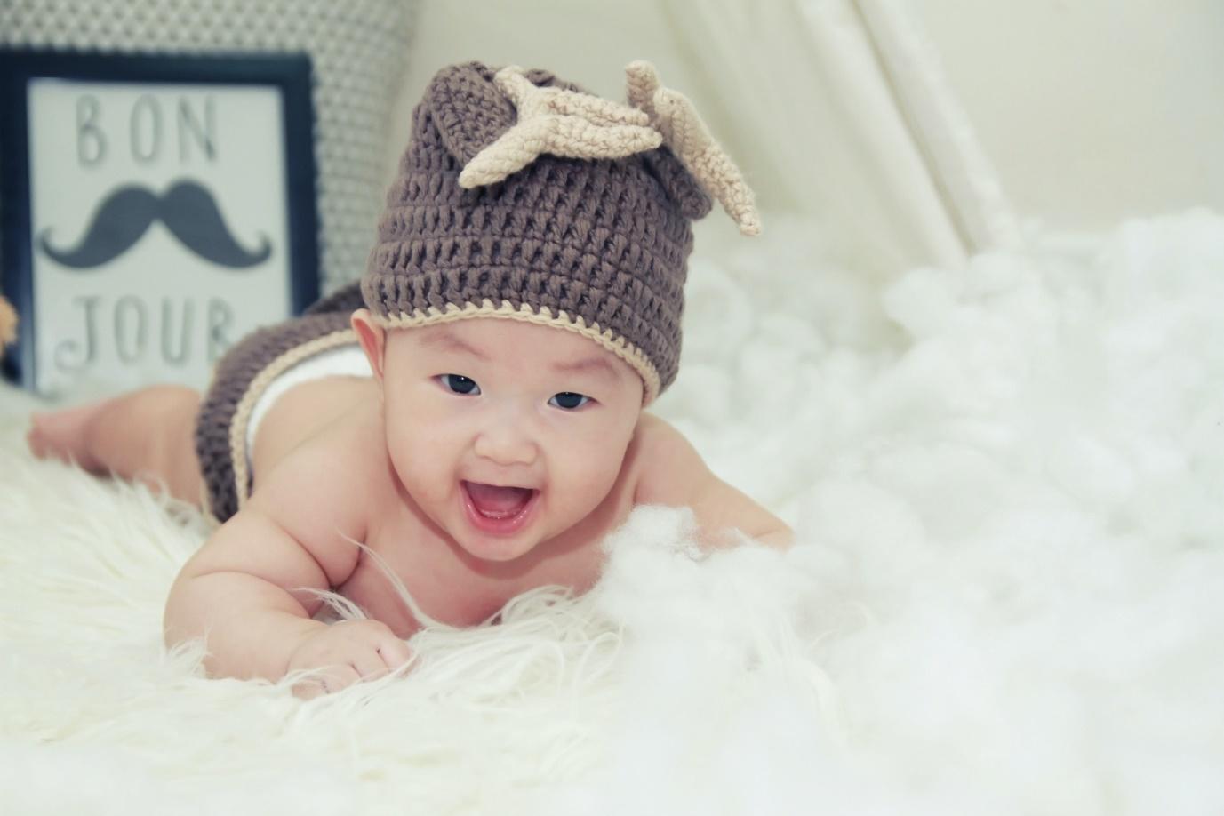 A newborn lying on the bed