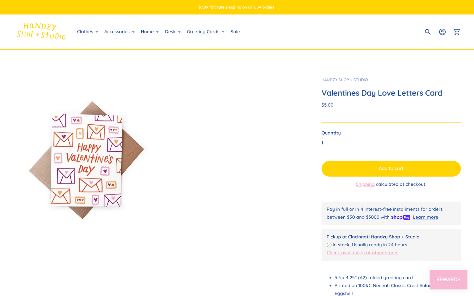 Valentine’s Day Gift Guide–A screenshot from Handzy Shop + Studio’s Valentine’s Day Love Letter Card product page showing a white card with pink, orange, red, and purple envelope illustrations on it. 