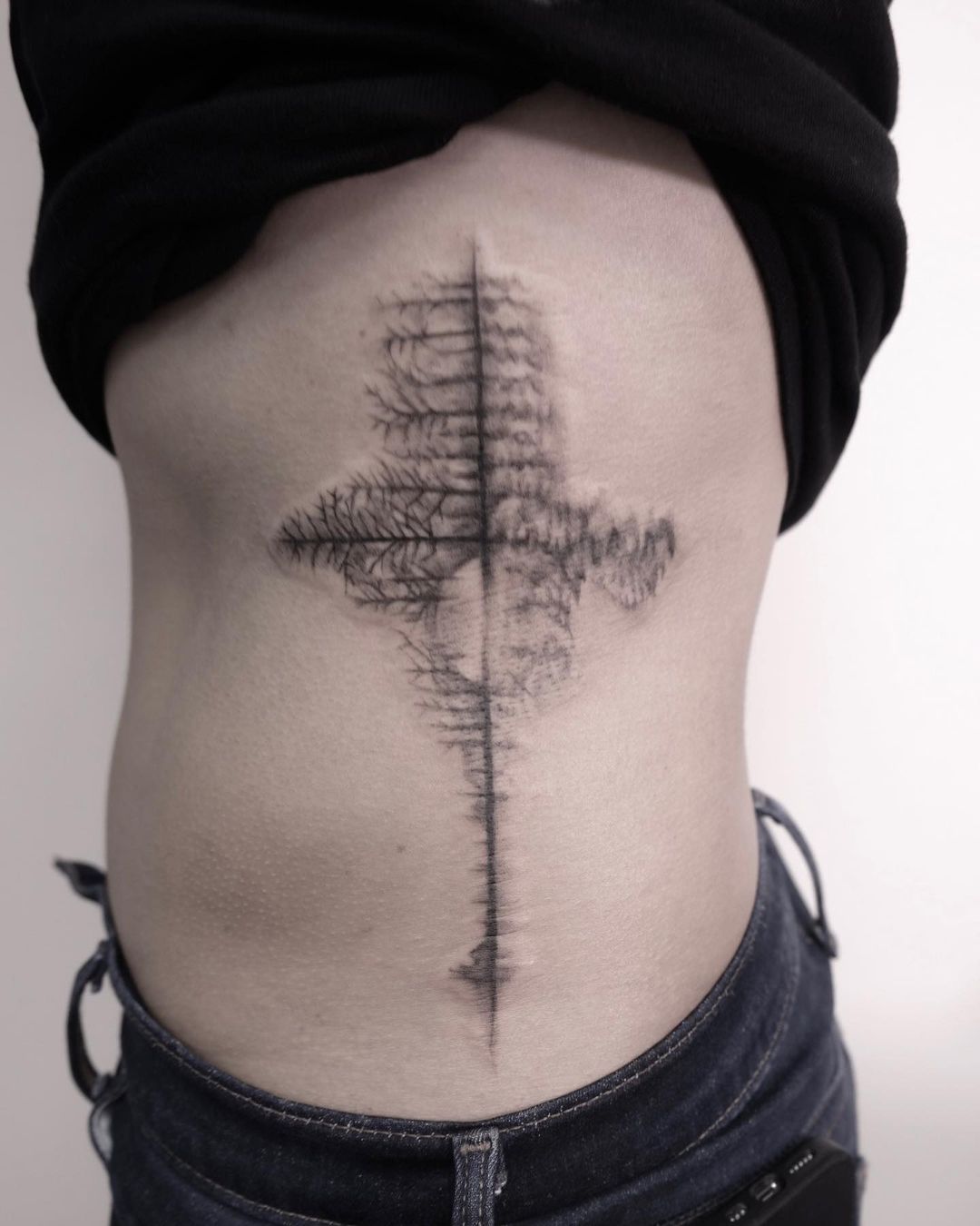 Cross with reflections of trees tattoo 