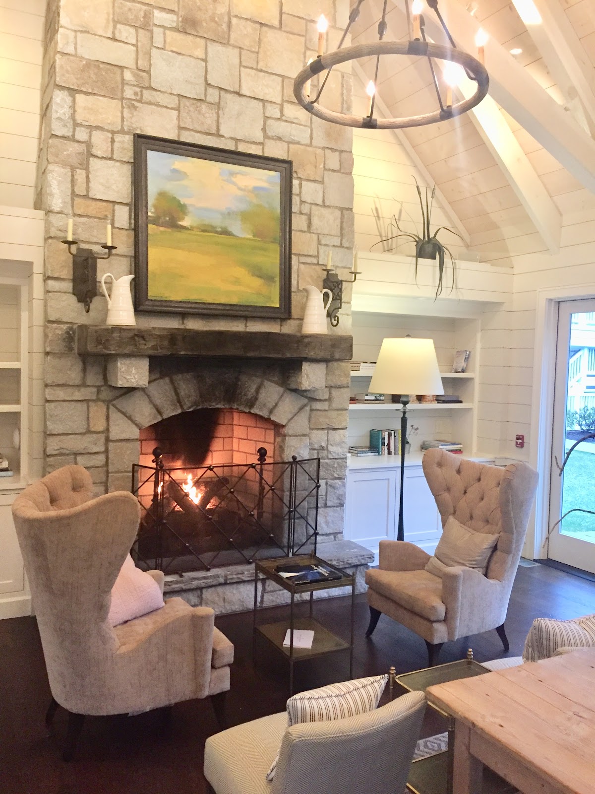 Stone Fireplace Burning With Chandelier
