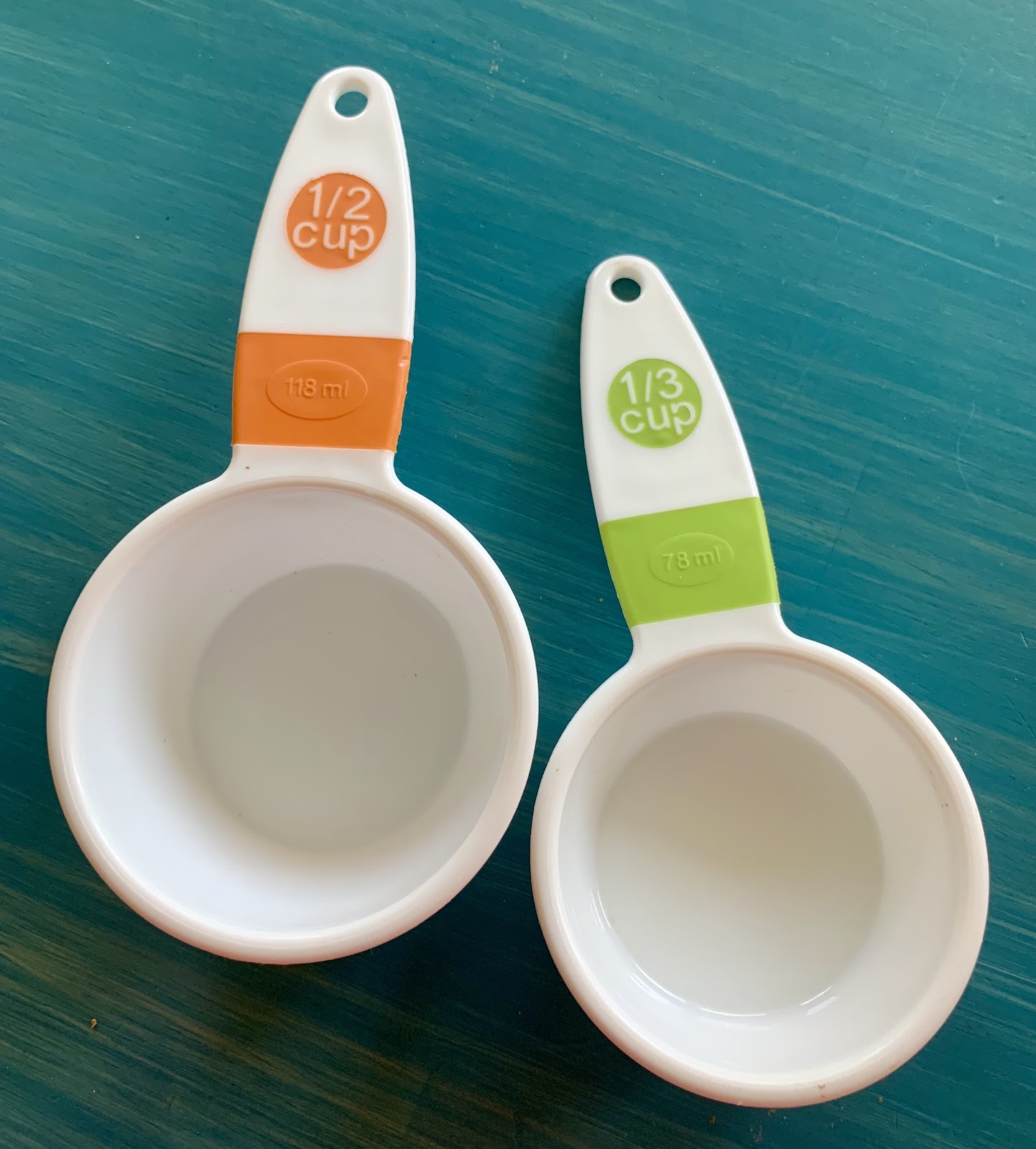 Measuring cups: 1-half cup and 1-third cup.