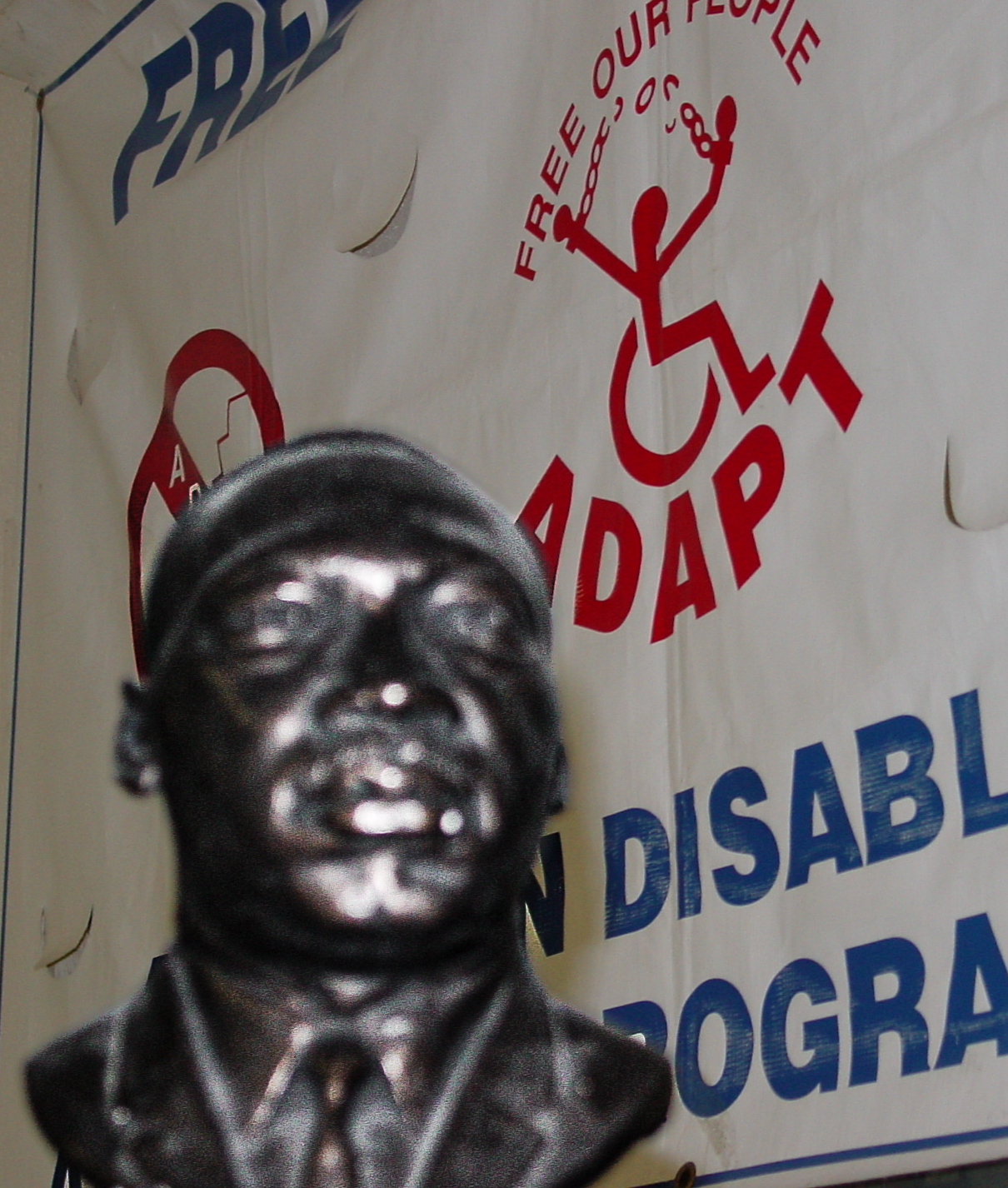 Martin Luther King bust in front of an ADAPT banner.