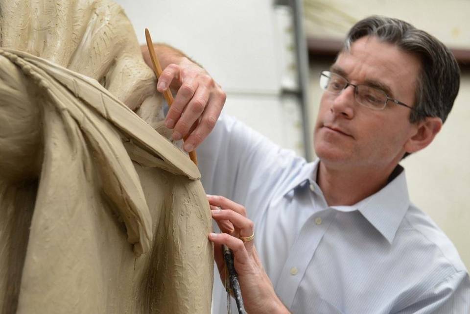 Chas Fagan, here at work in 2014 on the Charlotte sculpture of King Hagler, chief of the Catawba in the 1750s, and Thomas Spratt, a settler.