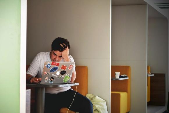 A person sitting at a table with a computer

Description automatically generated with low confidence