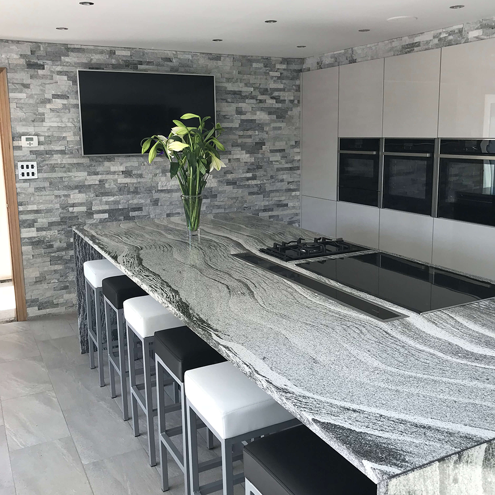 sparkle ice grey split face mosaic tiles used as a TV wall in a spacious kitchen