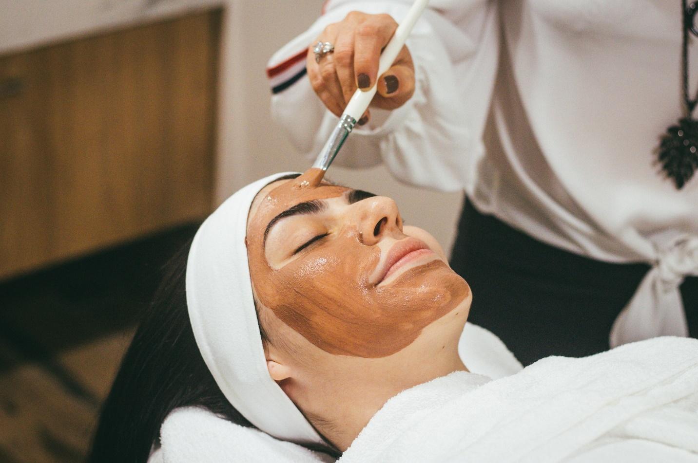 A skincare specialist working on a client