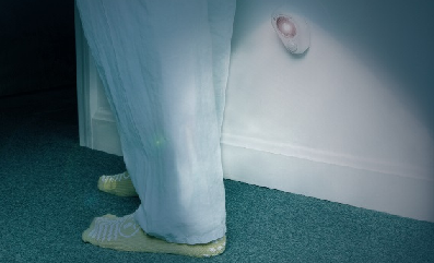 A person's feet in hallway with night light