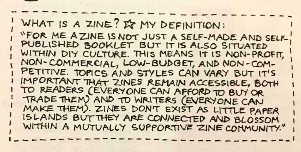 Index card titled "What is a Zine? [Star] My Definition:" with the definition: "For me a zine is not just a self-made and self-published booklet but it is also situated within DIY culture. This means it is non-profit, non-commercial, low-budget, and non-competitive. Topics and styles can vary but it's important that zines remain accessible, both to readers (everyone can afford to buy or trade them) and to writers (everyone can make them). Zine don't exist as little paper islands but they are connected and blossom within a mutually supportive zine community."
