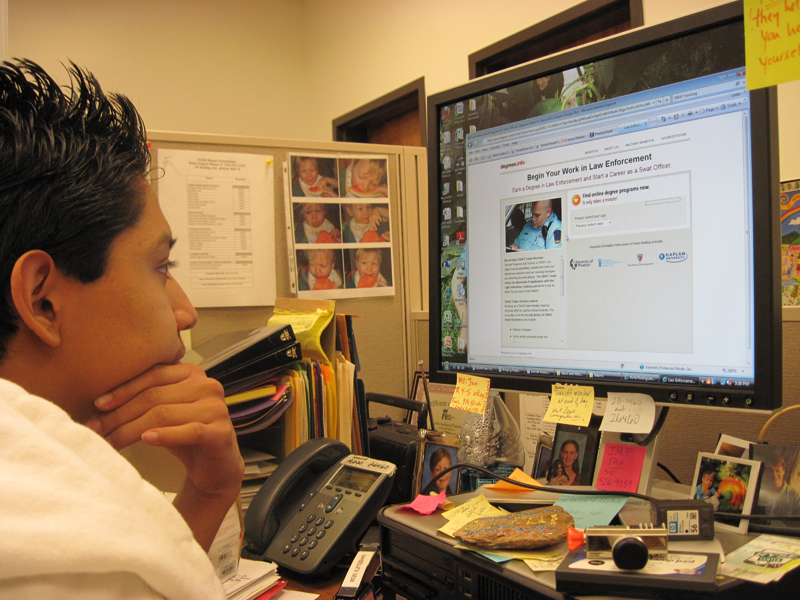 An adolescent boy works on a computer in the health center. Photo credit: James Morehouse Project, El Cerrito High School