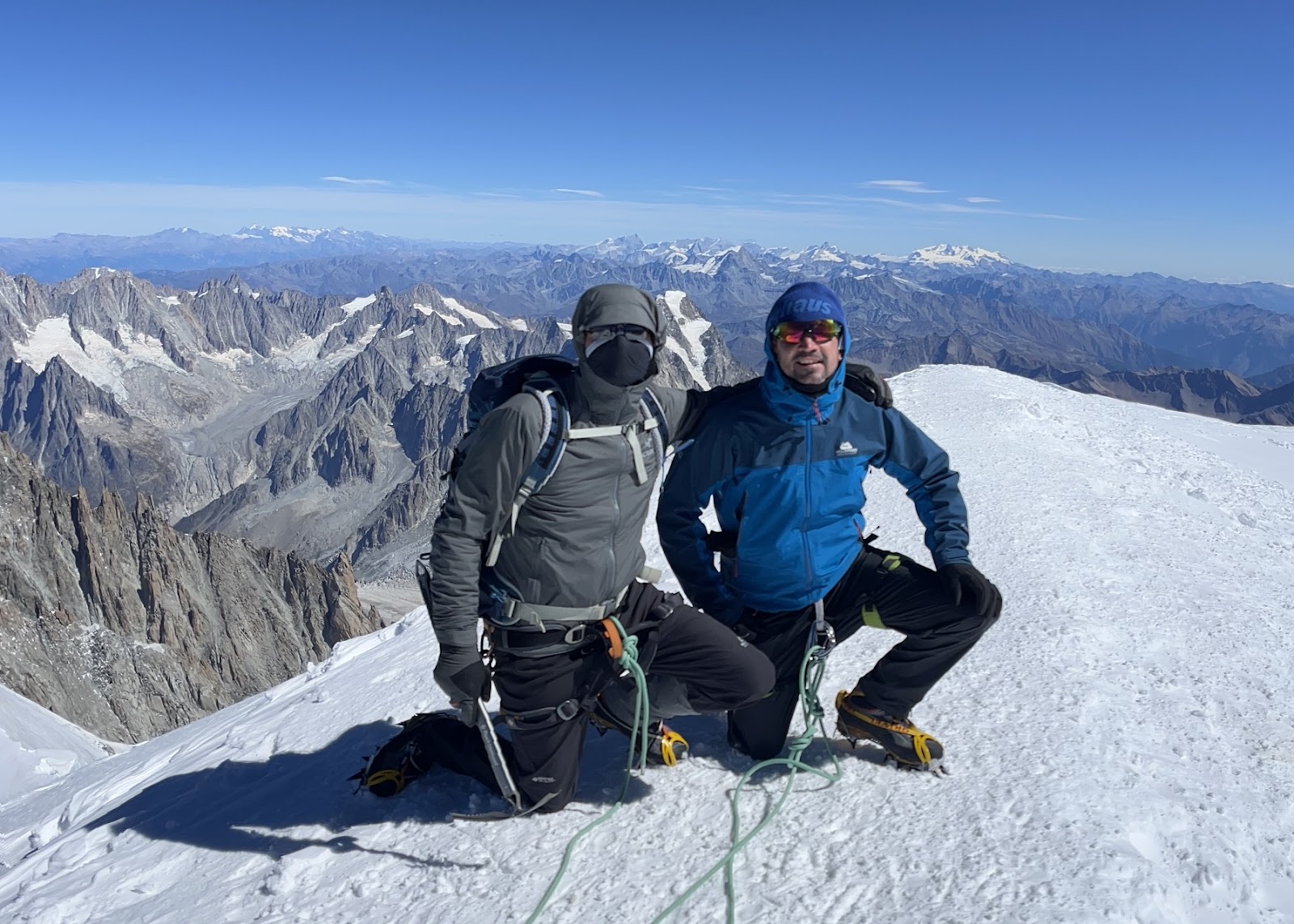 Climbers crouched on the summit of Mont Blanc, France