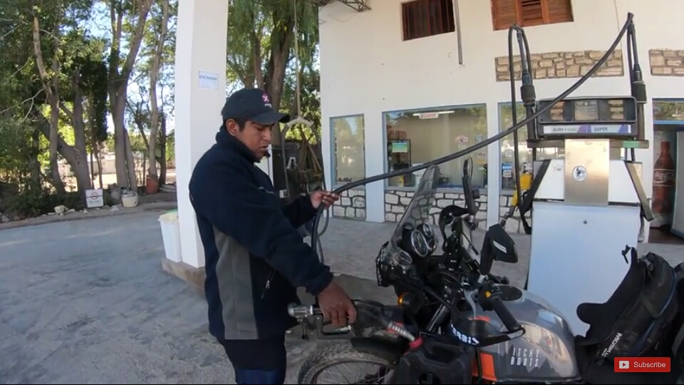 Filling to extra fuel cans of her bike