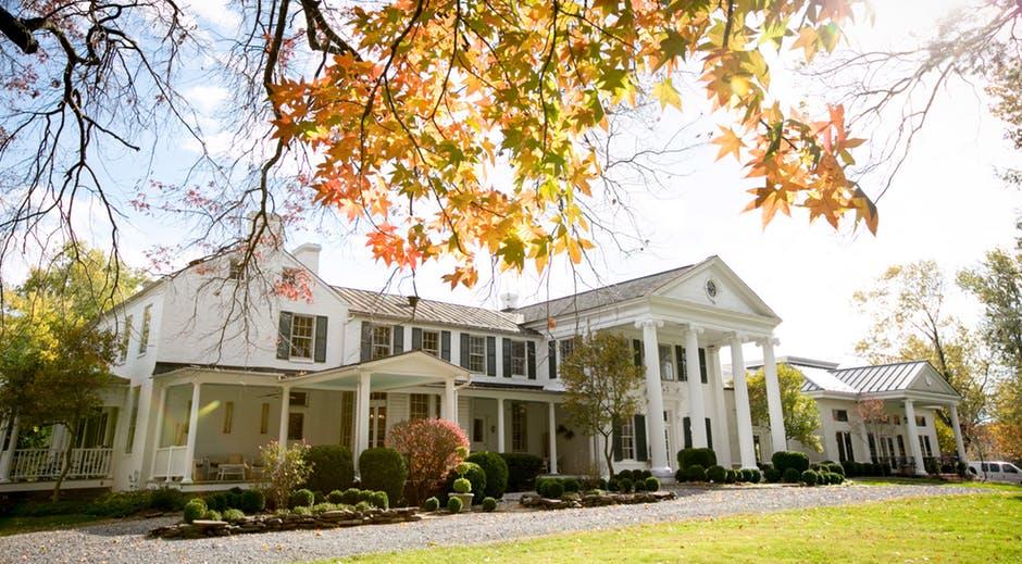 white home with autumn leaves