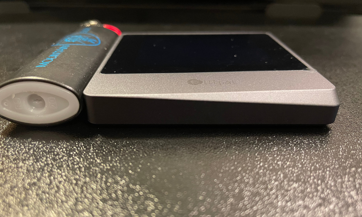 Ellipal Titan Mini next to a lighter to show thickness and its enclosed aluminum casing.