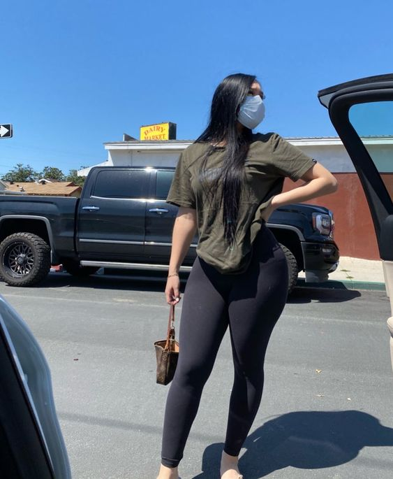Woman wearing face mask and top and leggings