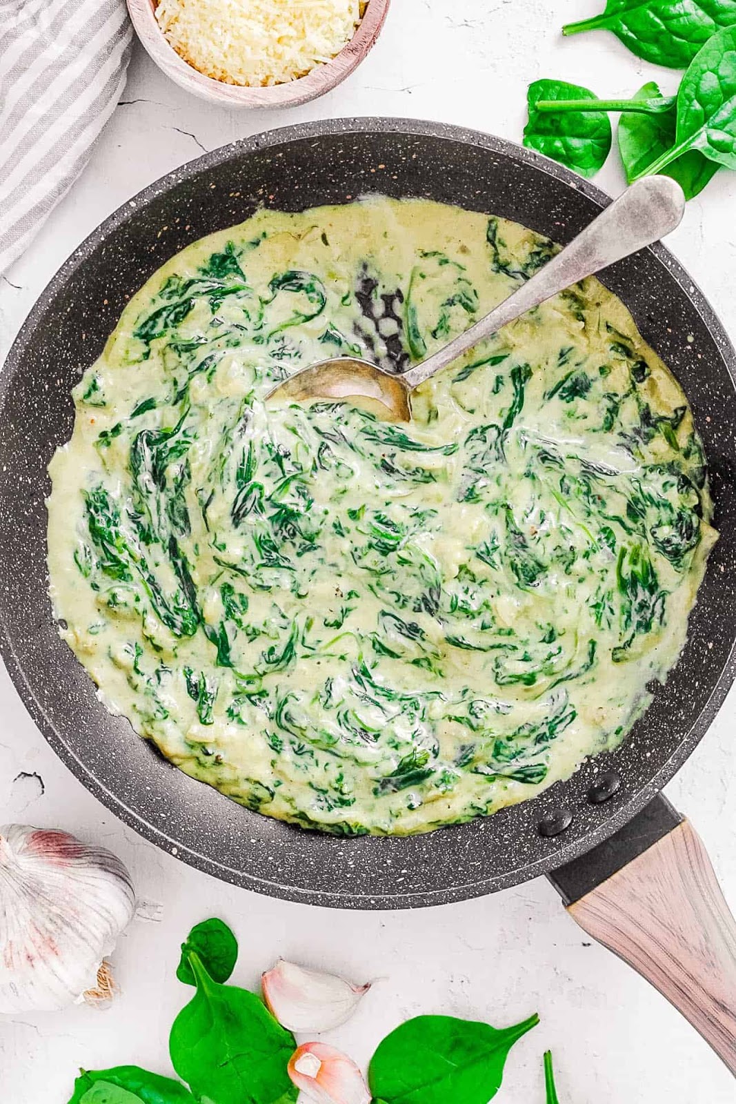 Creamed spinach dip in a black pan.