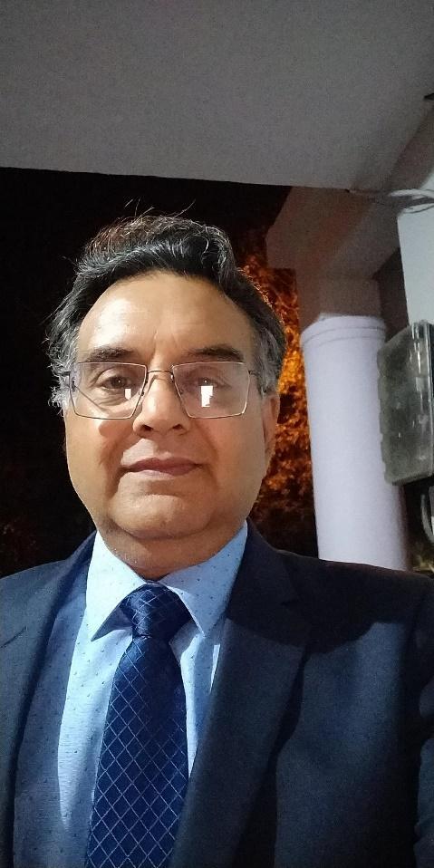 A person wearing glasses and a suit
Description automatically generated with medium confidence