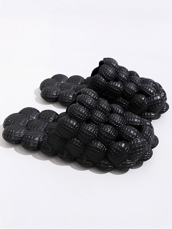 a picture of black golf ball slippers