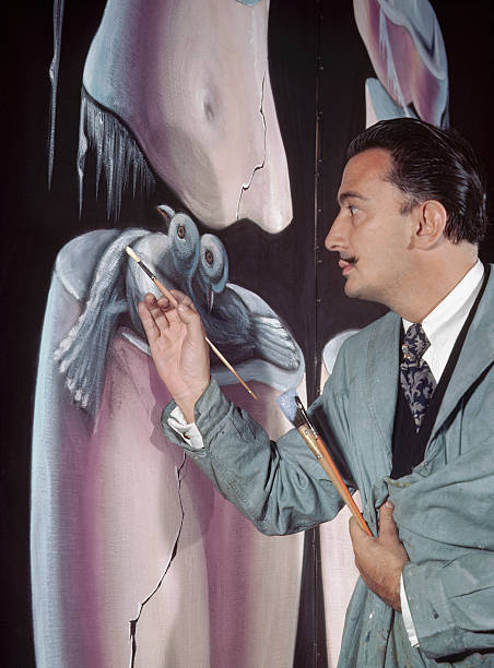 The surrealist painter Salvador Dali works on the figure of two birds in a large oil composition, Greenwich Village, New York.