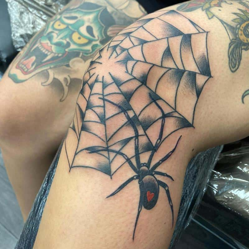 Full picture of a guy rocking the web tattoo on his kneecap