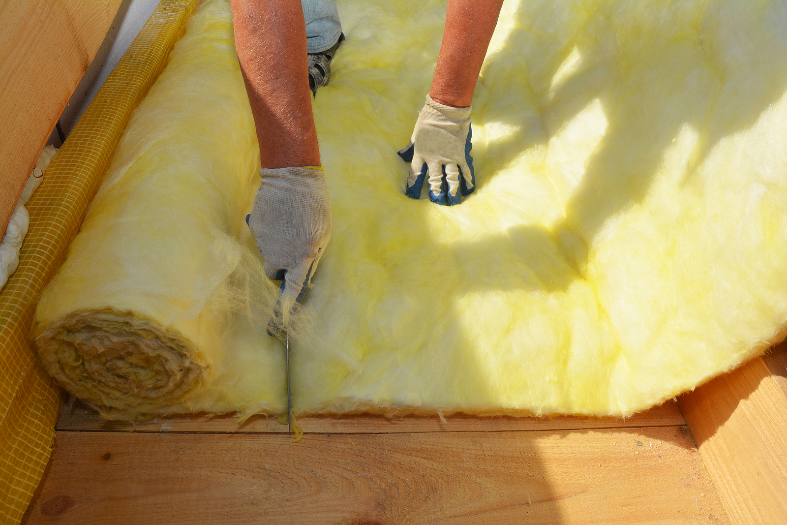 Professional technician installing Wisconsin insulation in home