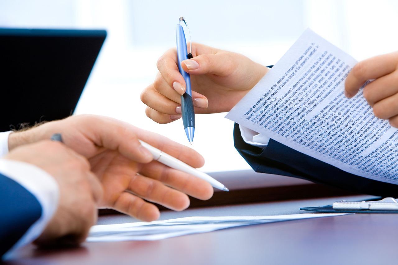 two people completing documents