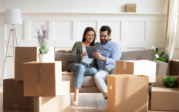 A couple looking at their iPad to plan a budget-friendly move