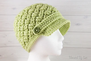 green crochet newsboy cap on mannequin