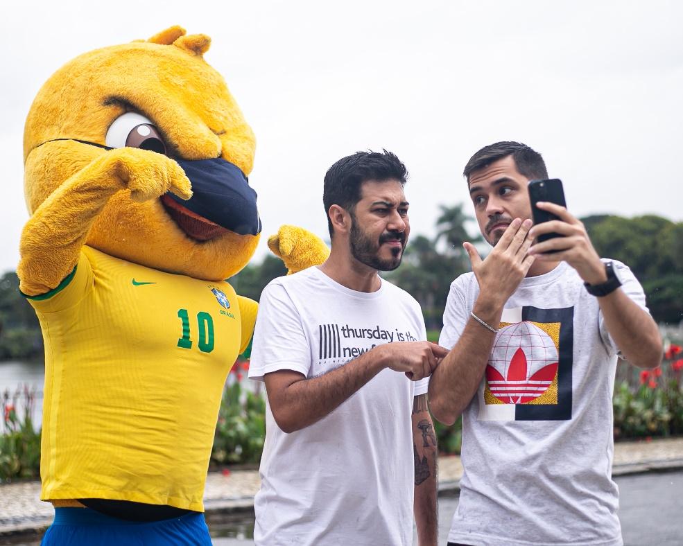 A group of men taking a selfie with a person in a garment

Description automatically generated with medium confidence