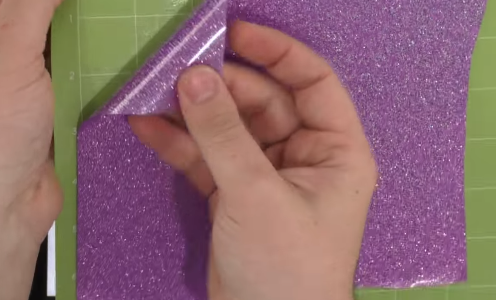 Placing glitter HTV on a cutting mat