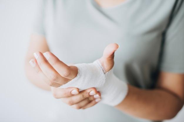 Free photo woman with gauze bandage wrapped around her hand