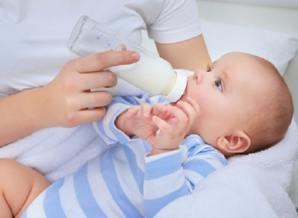 A picture containing baby, person, indoor, holding

Description automatically generated