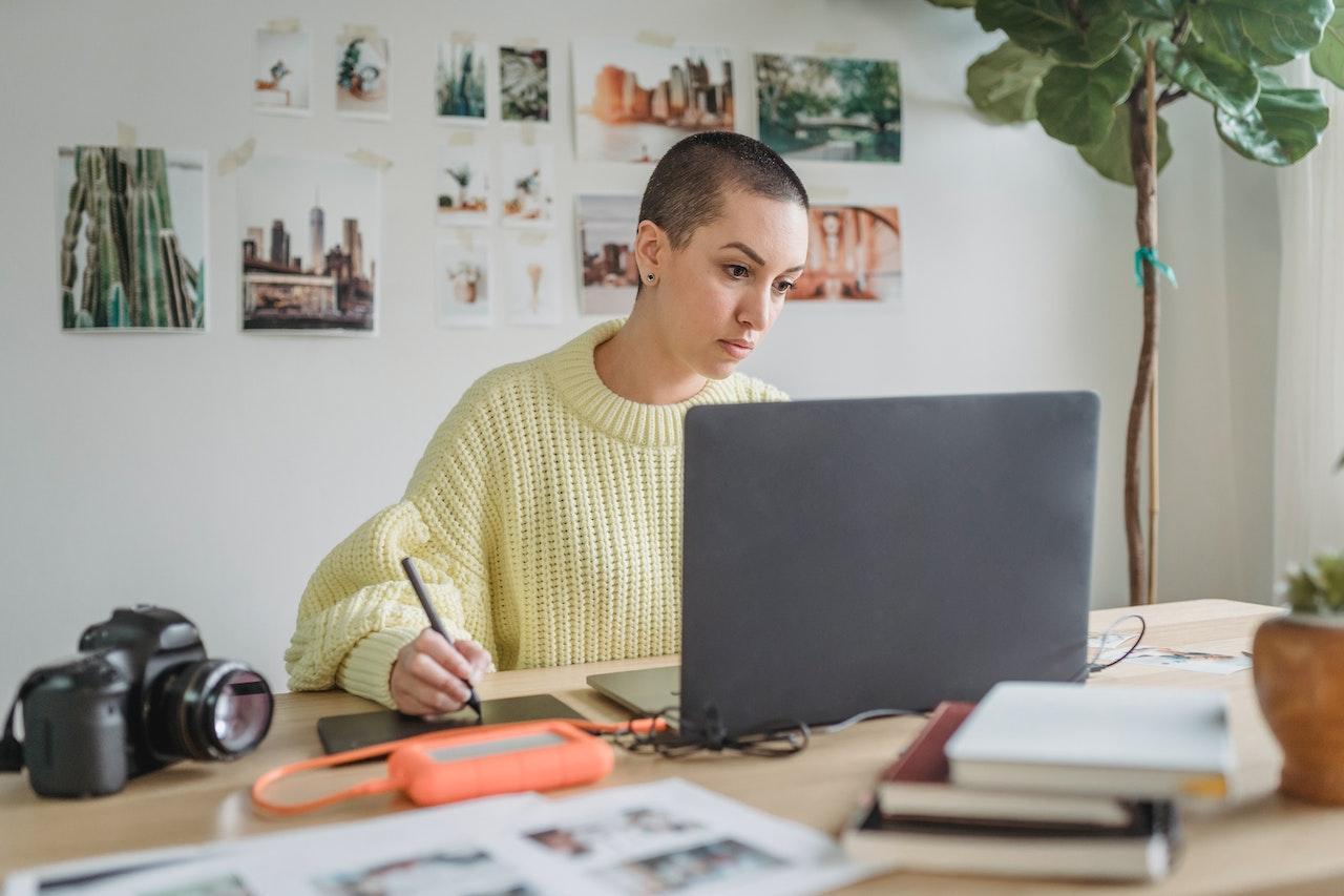 A woman discovering how to make her business stand out on a laptop.